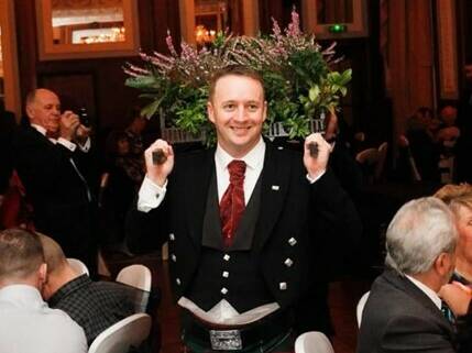 Gentleman in a kilt ceremonial haggis parade on burns night atat St Georges Hotel Llandudno