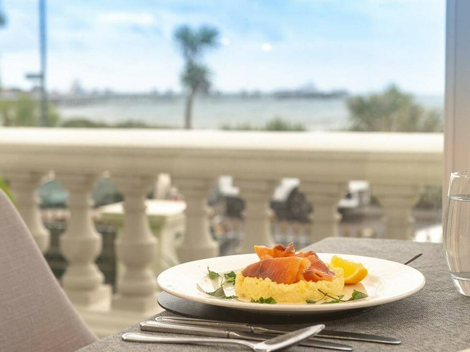 plate of salmon on scrambled eggs with gorgeous sea view from terrace restaurant St George's Hotel