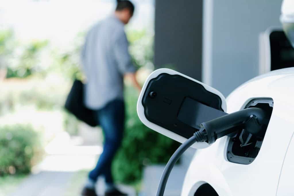 Focus,Electric,Car,Charging,At,Home,Charging,Station,With,Blurred