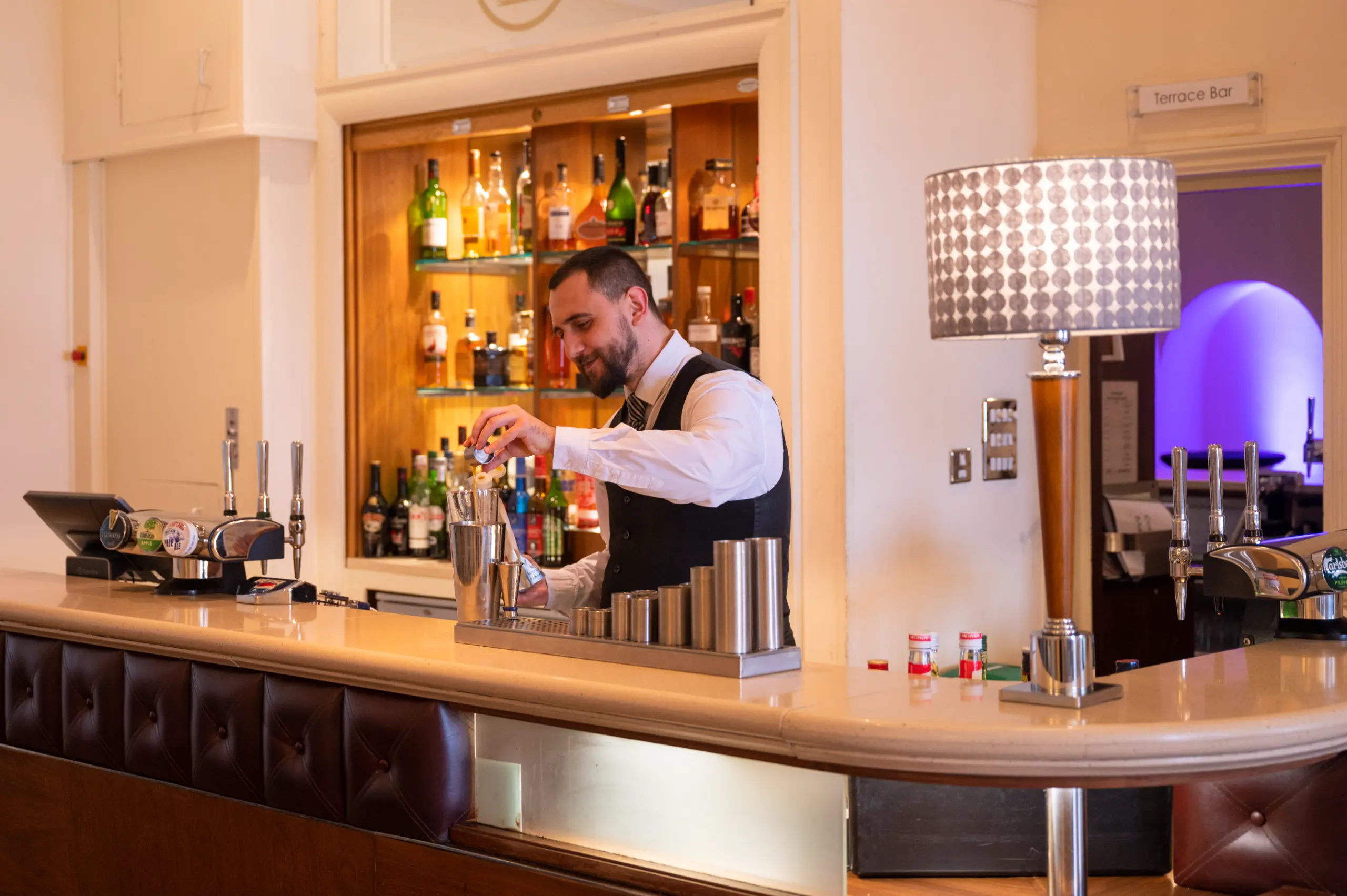 staff member pouring a drink